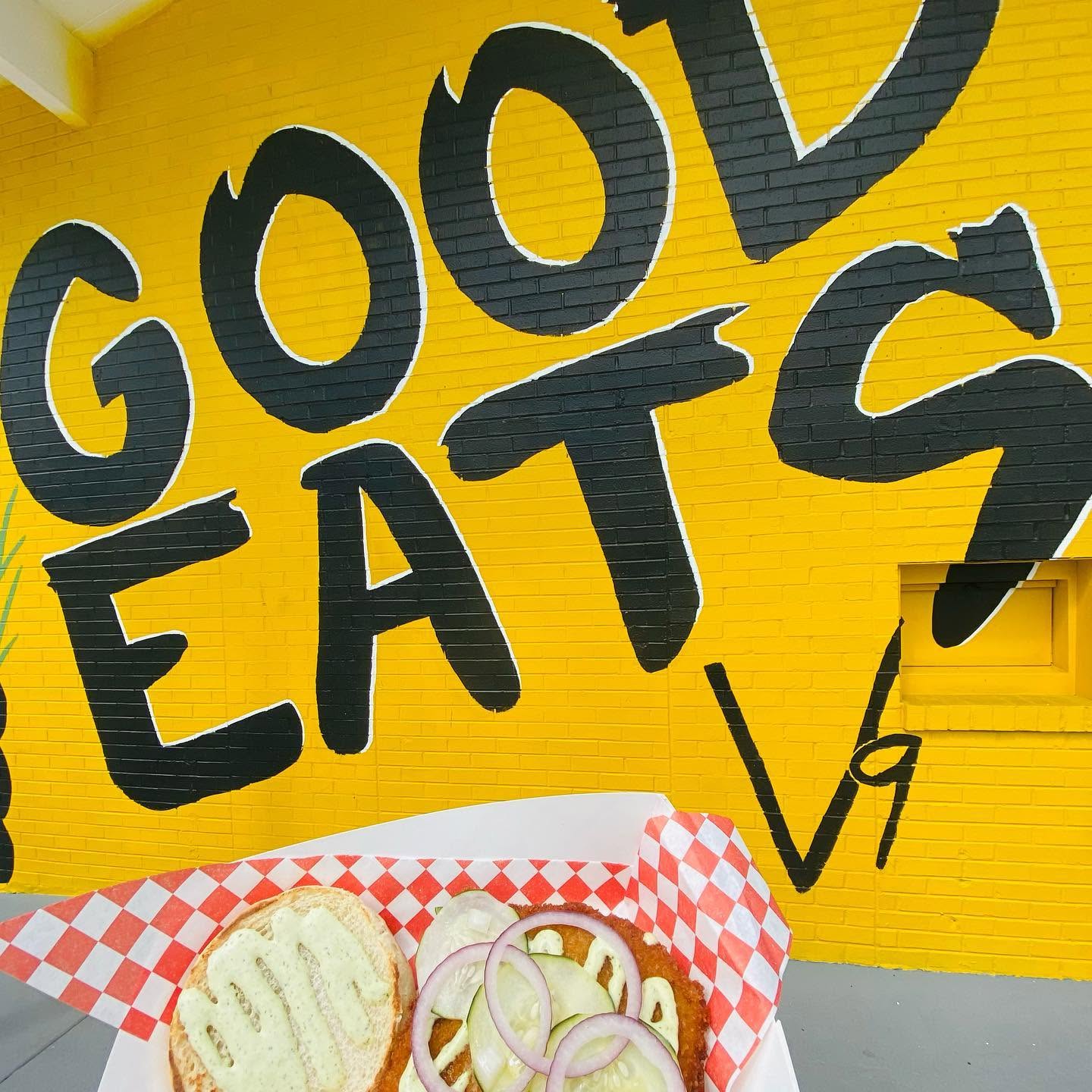 The GOOD EATS wall in sunflower yellow with a sandwich basket in front