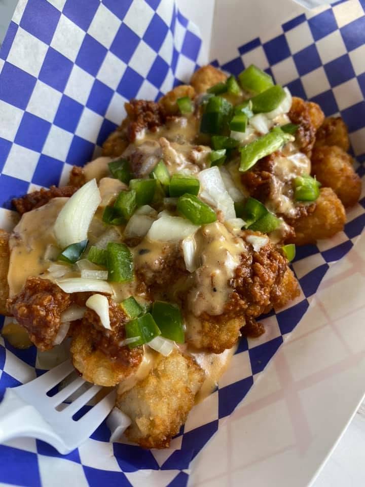 Loaded tots with chili, cheese sauce and jalapeño