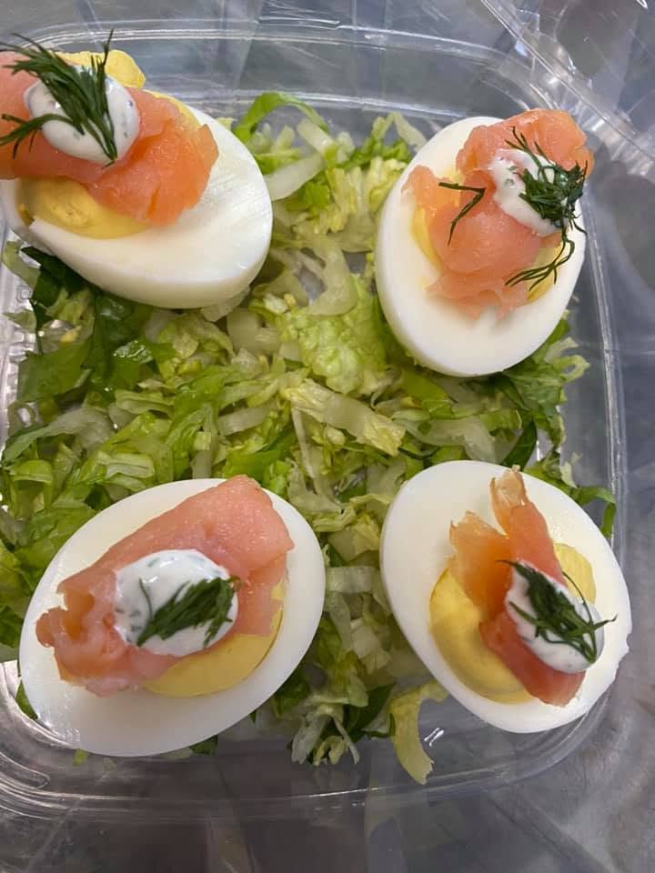 Smoked salmon deviled eggs on shredded lettuce