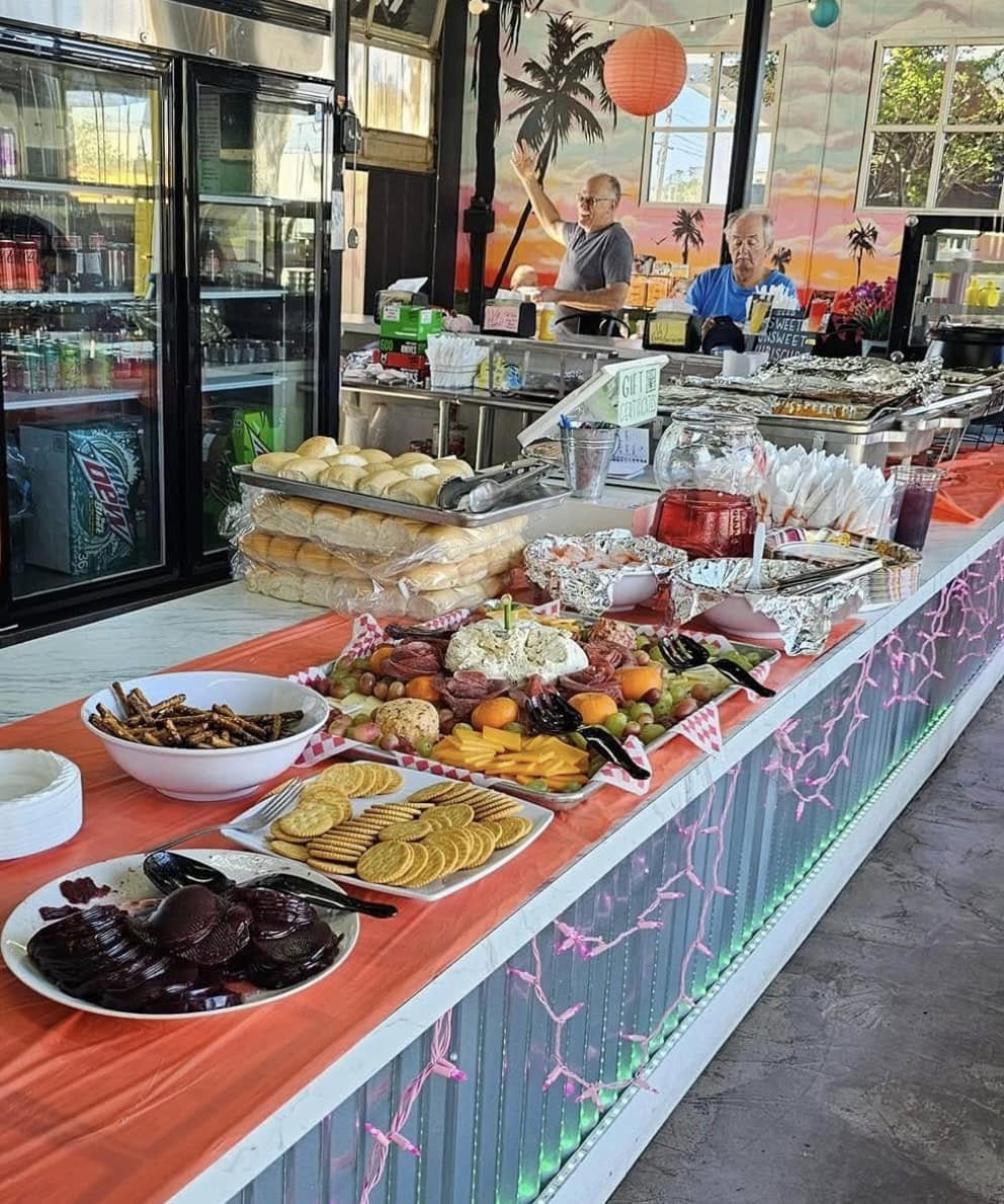 A buffet set out along V9's counter with staff behind it