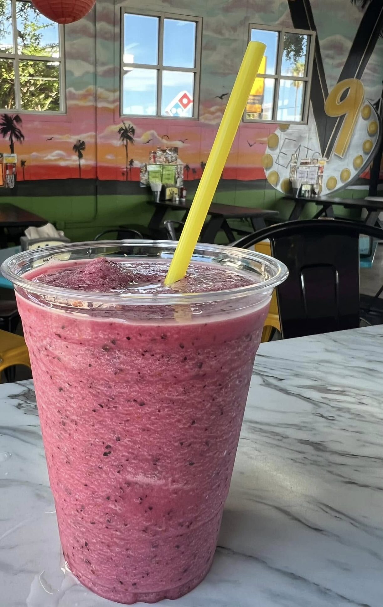 A smoothie on the counter in the mural-painted dining room