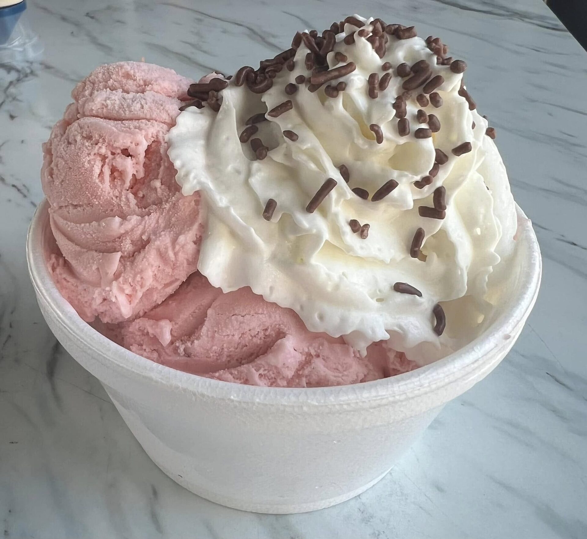 Ice cream with whipped cream and sprinkles