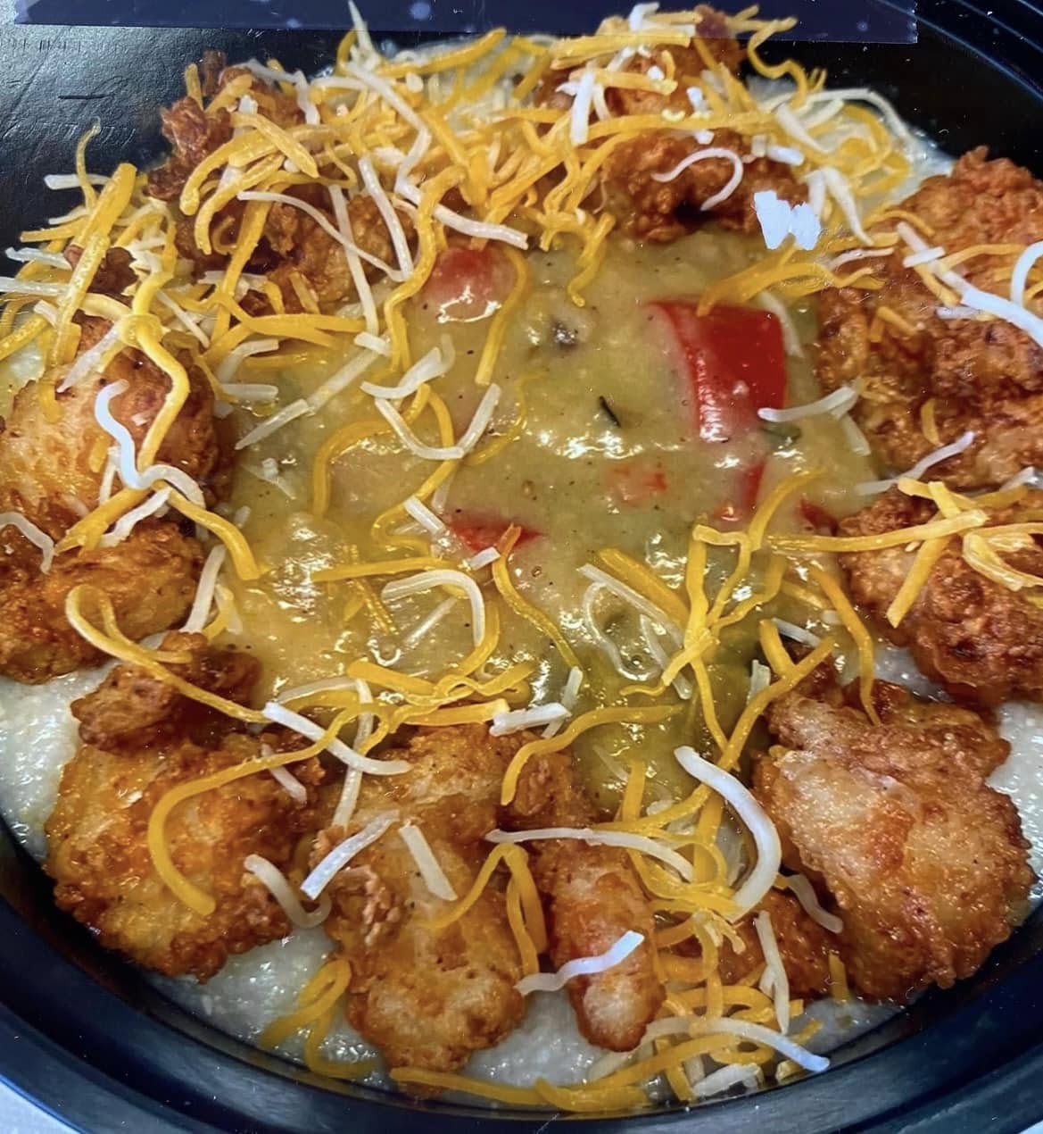 Fried shrimp over cheesy grits