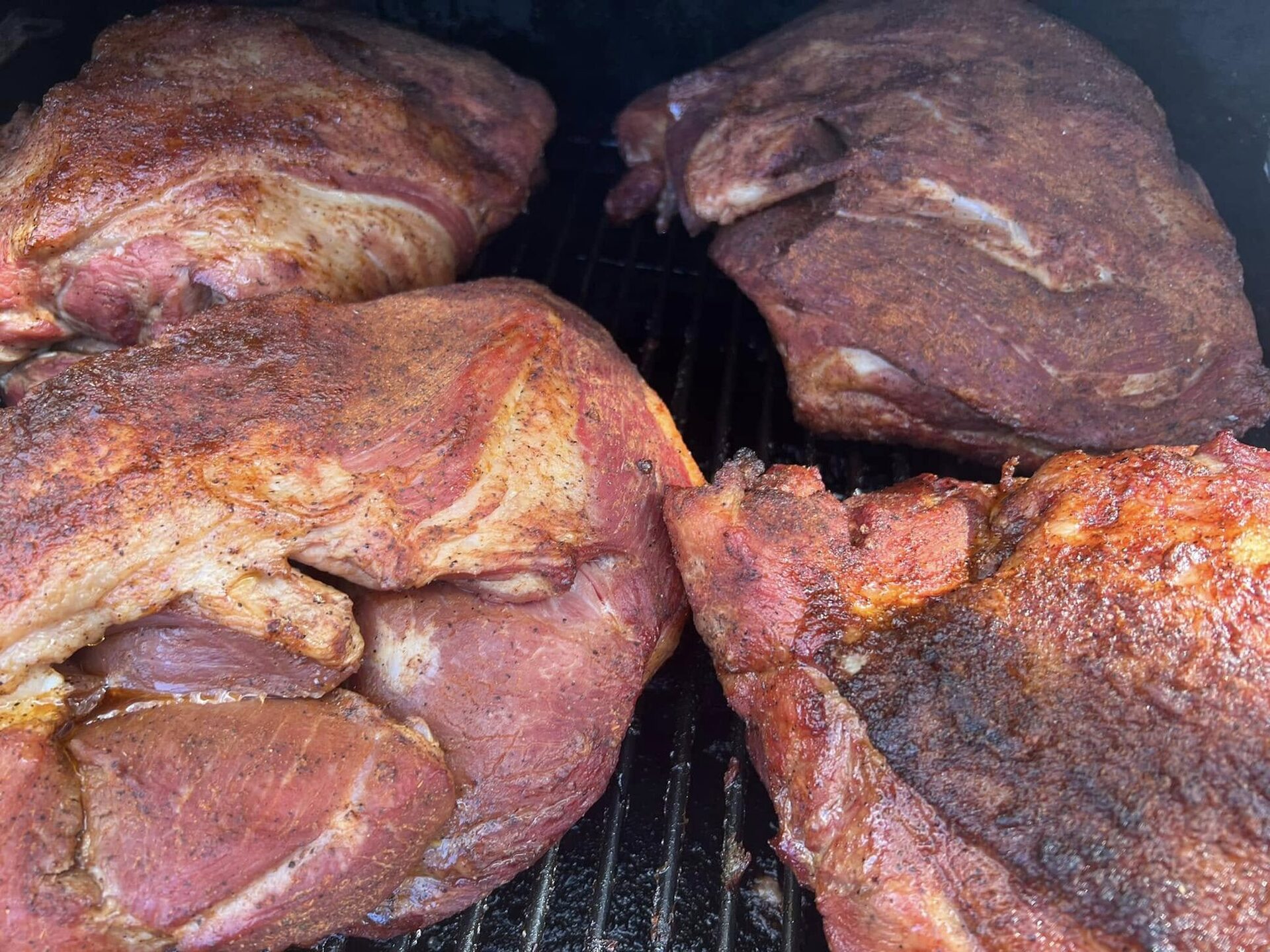 Pork shoulders smoking on the grate