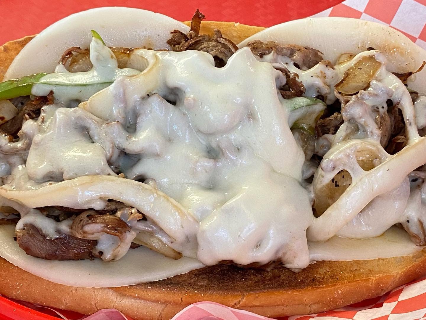 Steak and cheese sub with peppers and melted cheese