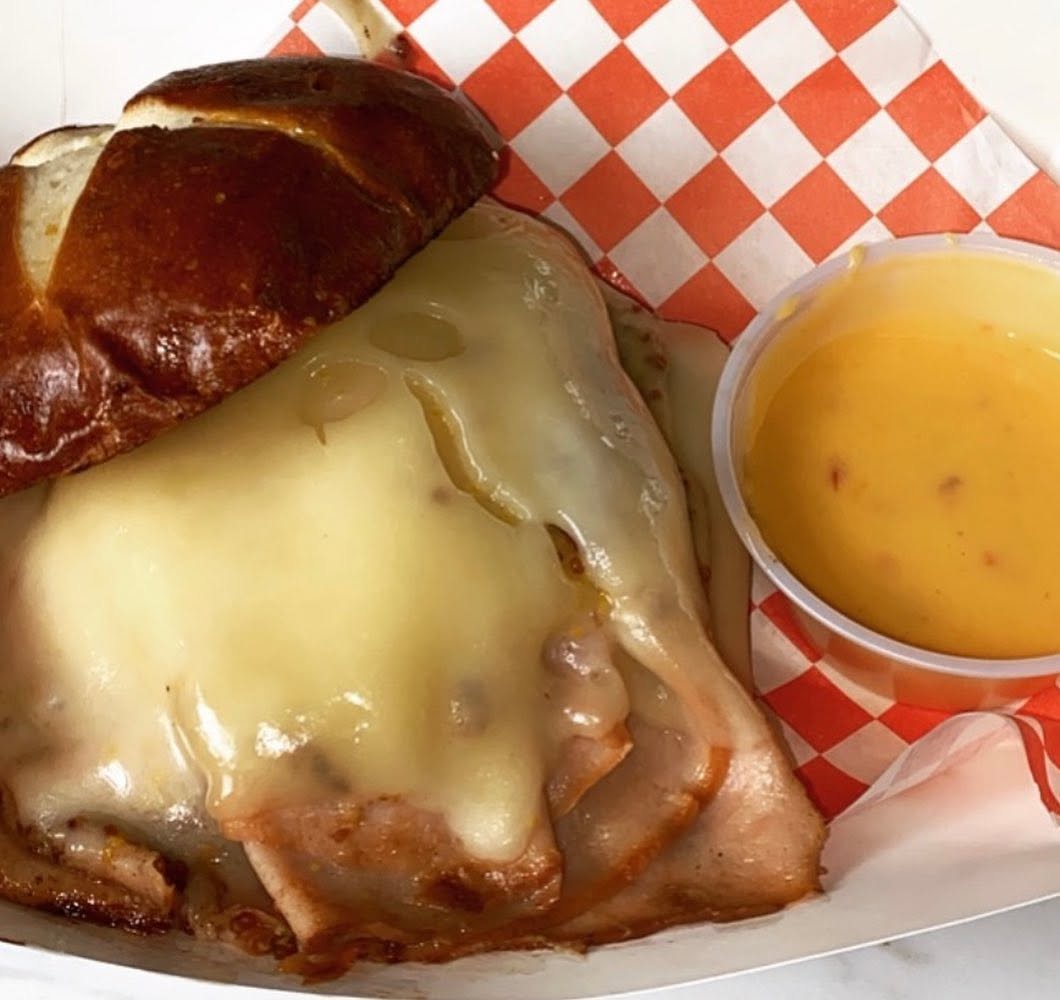 Hot Turkey O'Drool on a pretzel roll with cheese sauce