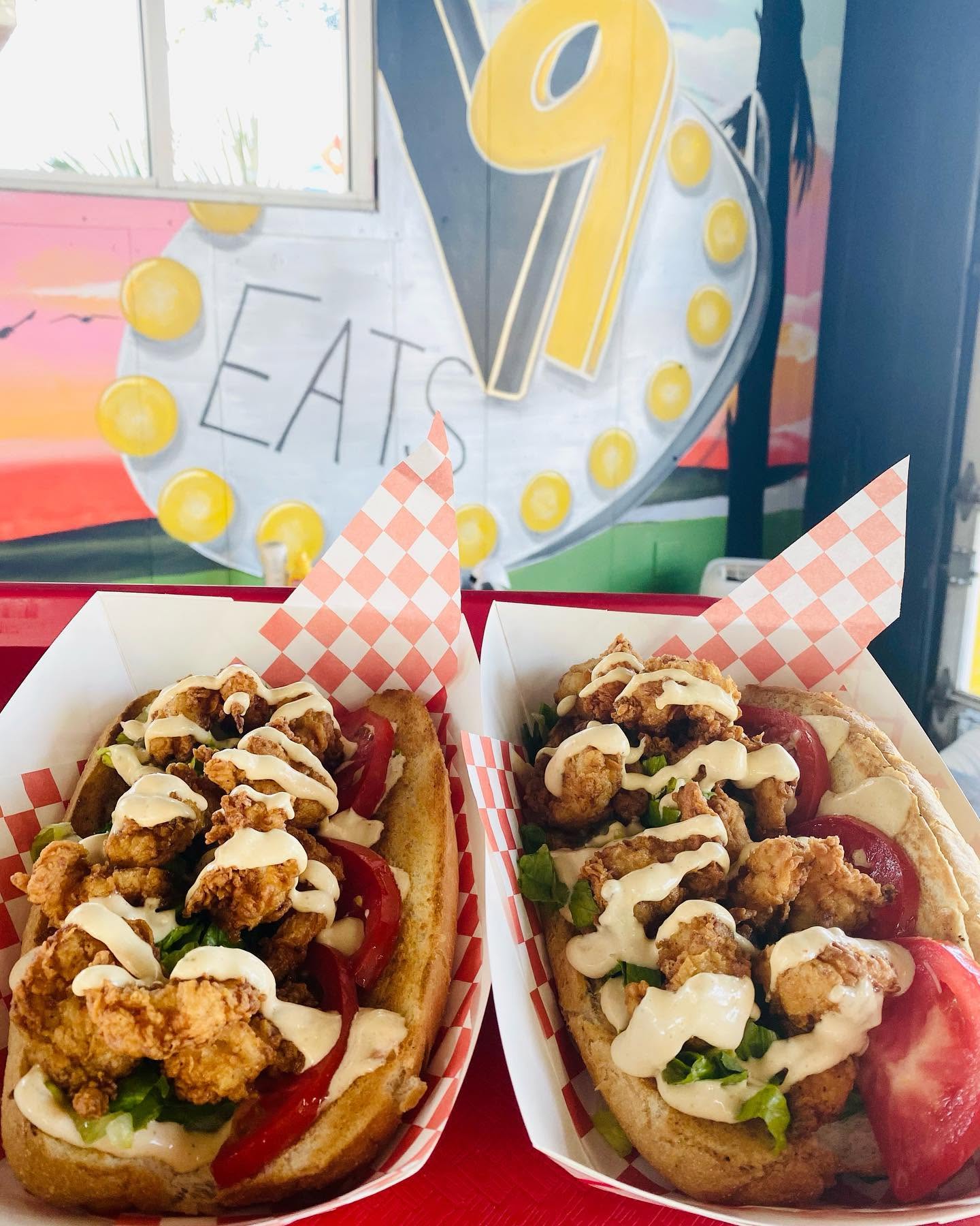 Two loaded dogs under the marquee sign